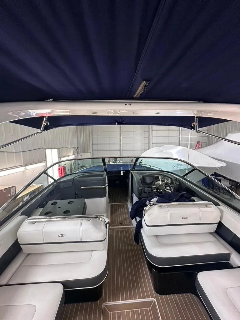 Slide: The Image of 2015 Regal 2800 Bowrider interior with seating and steering wheel in a covered area. - 15