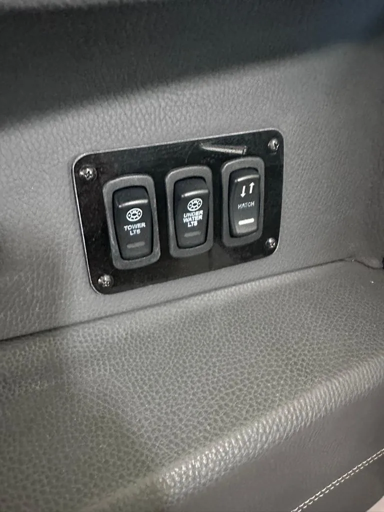 Slide: The Image of Control panel of a 2015 Regal 2800 Bowrider boat with toggle switches. - 16