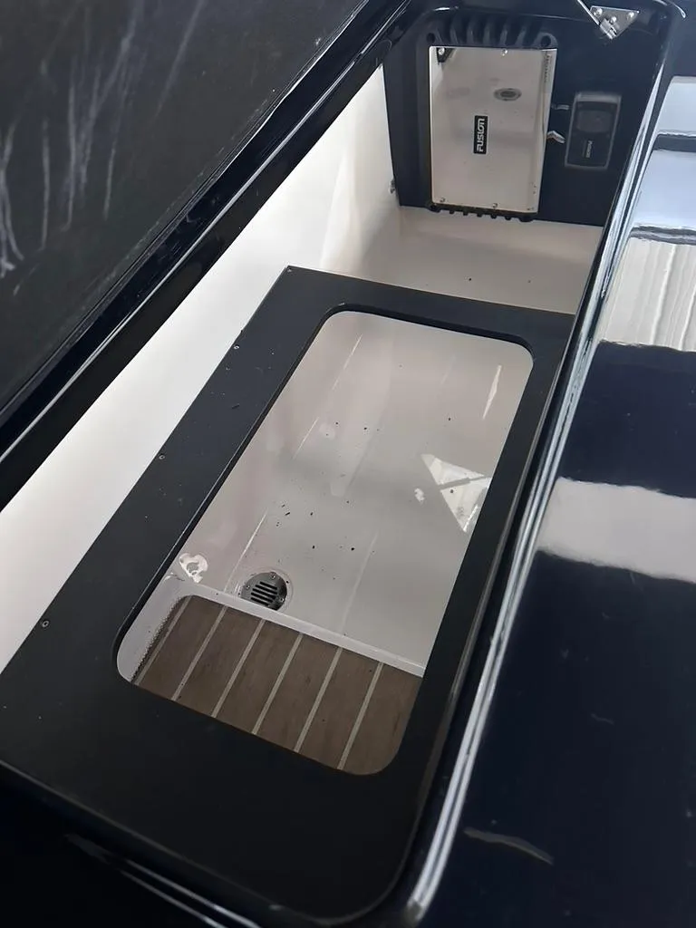 Slide: The Image of Storage compartment of 2015 Regal 2800 Bowrider boat, featuring a sleek design. - 18