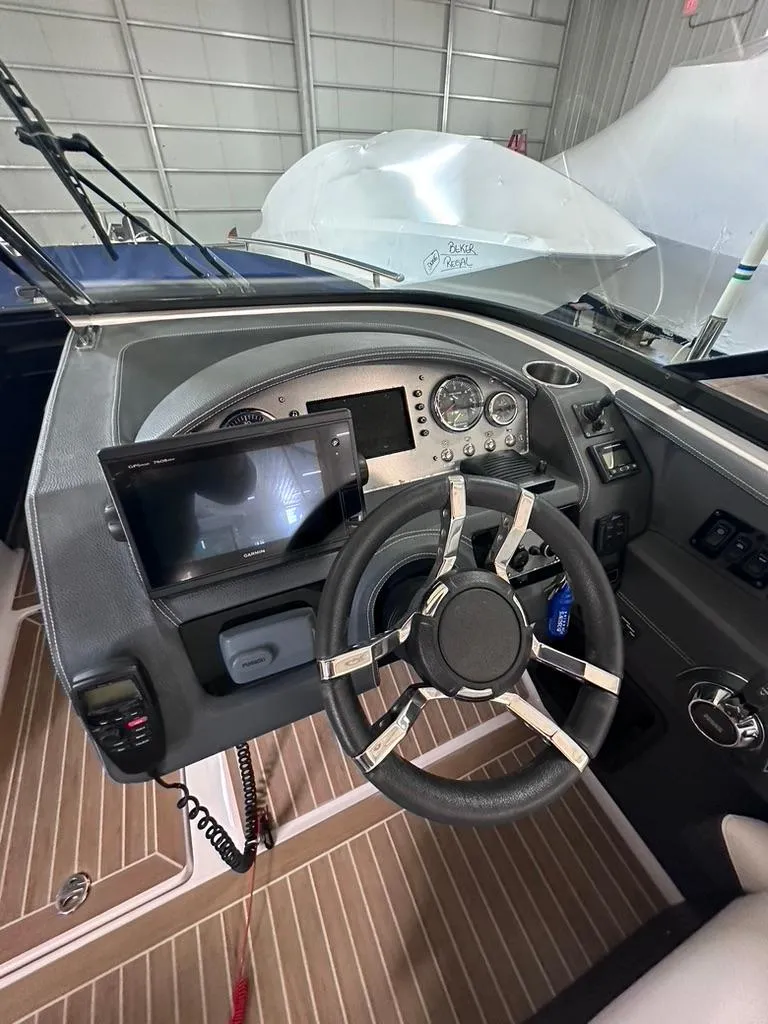 Slide: The Image of 2015 Regal 2800 Bowrider dashboard with steering wheel and navigation display. - 8