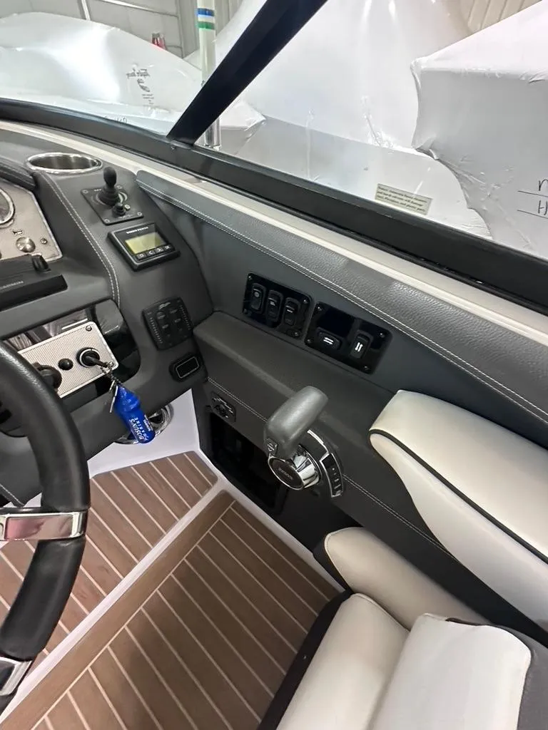Slide: The Image of Interior of 2015 Regal 2800 Bowrider boat, featuring dashboard and controls. - 9