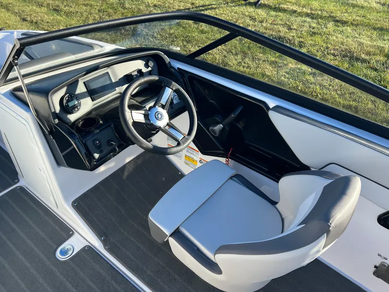 Slide: The Image of 2025 Yamaha Boats SX190 cockpit with steering wheel and captain's chair. - 12