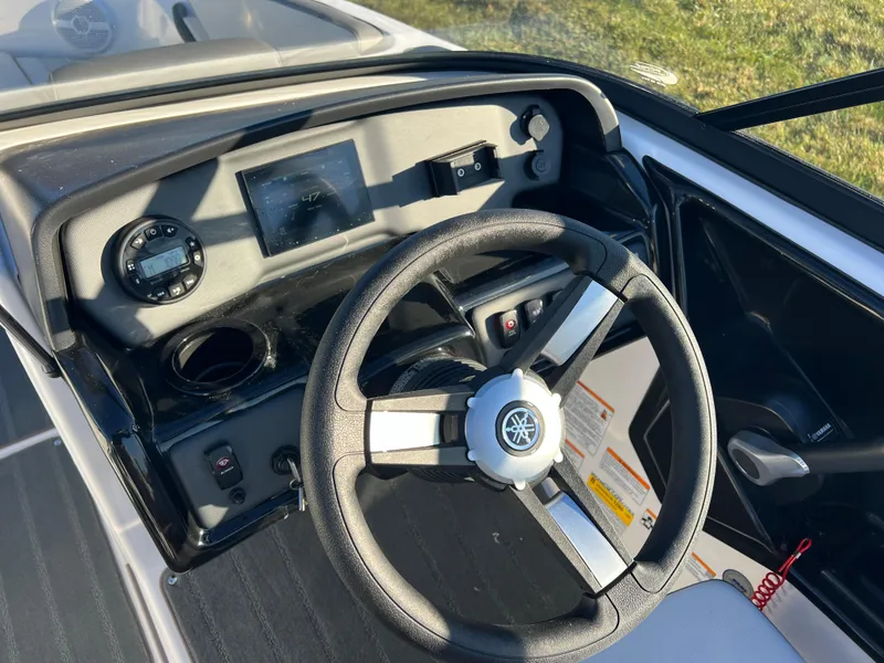 Slide: The Image of 2025 Yamaha Boats SX190 dashboard with steering wheel and controls. - 14