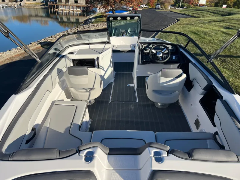 Slide: The Image of 2025 Yamaha Boats SX190 interior, spacious seating, modern design, waterfront view. - 9