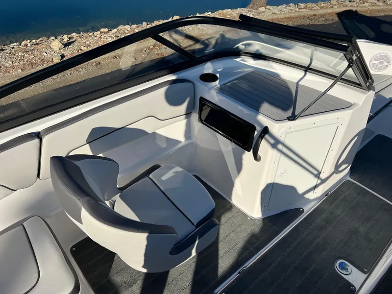 Slide: The Image of 2025 Yamaha Boats SX190 interior with sleek seating and modern dashboard design. - 11