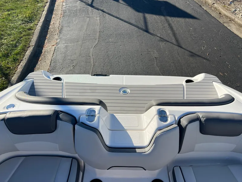 Slide: The Image of 2025 Yamaha Boats SX190 rear deck with seating and cup holders. - 22