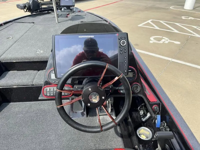 Slide: The Image of 2018 Legend Trailers V20 boat dashboard with Humminbird navigation system and steering wheel. - 14