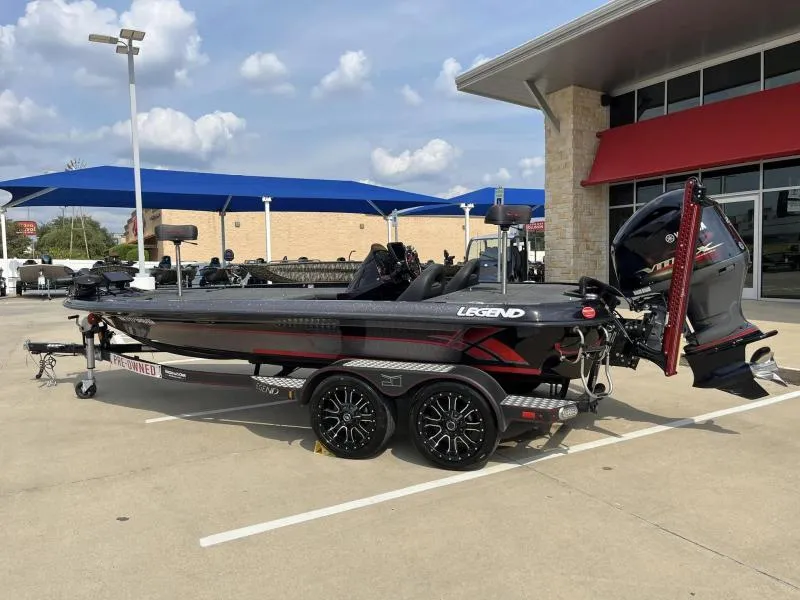 Slide: The Image of 2018 Legend Trailers V20 boat on display in a parking lot. - 2