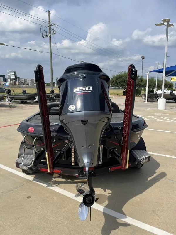 Slide: The Image of 2018 Legend Trailers V20 boat with powerful 250 horsepower engine, parked outdoors. - 3