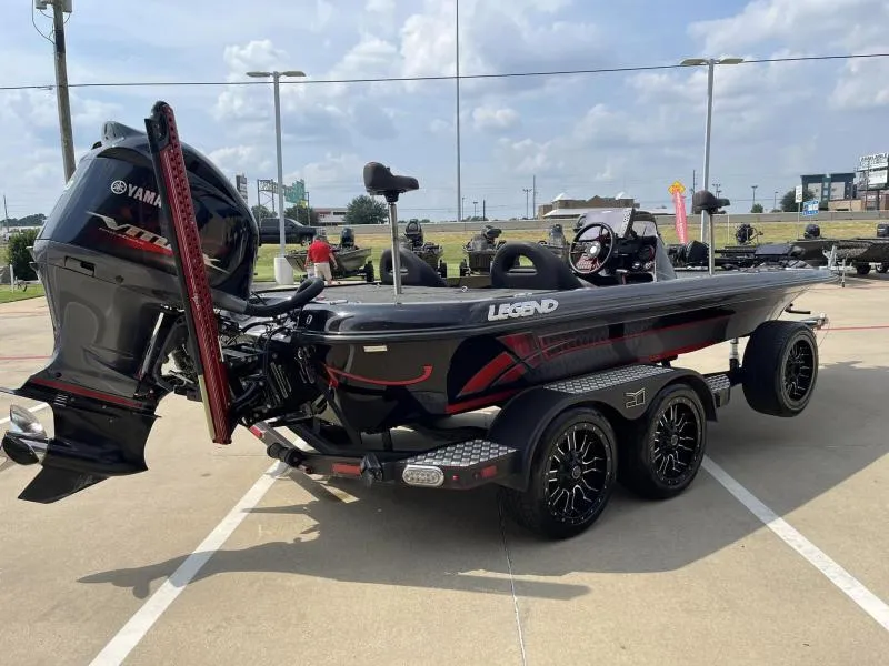 Slide: The Image of 2018 Legend Trailers V20 boat with Yamaha motor, parked outdoors on a sunny day. - 4