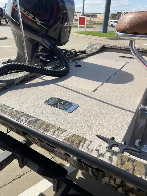 Slide: The Image of 2025 Avid 18 Center Console boat with Yamaha 115 engine, camo trim, and tan deck. - 13