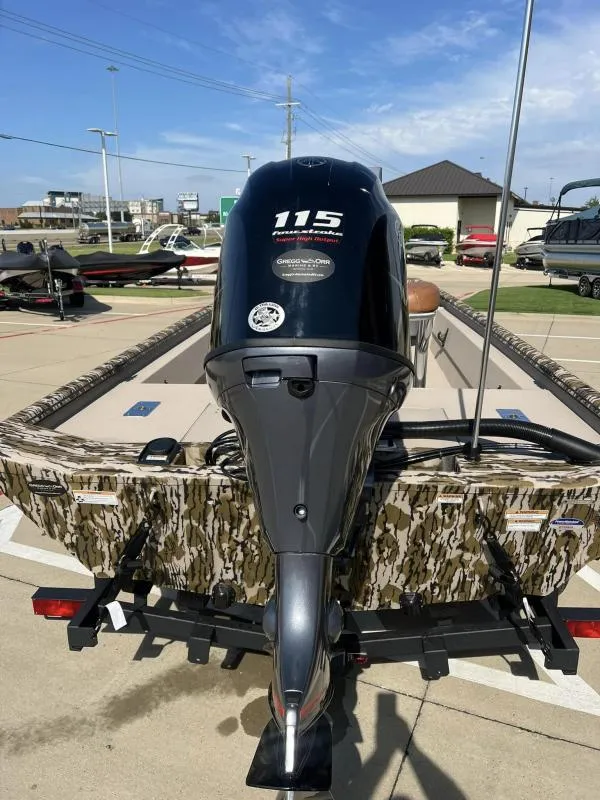 Slide: The Image of 2025 Avid 18 Center Console boat with camouflage design and powerful outboard motor. - 14