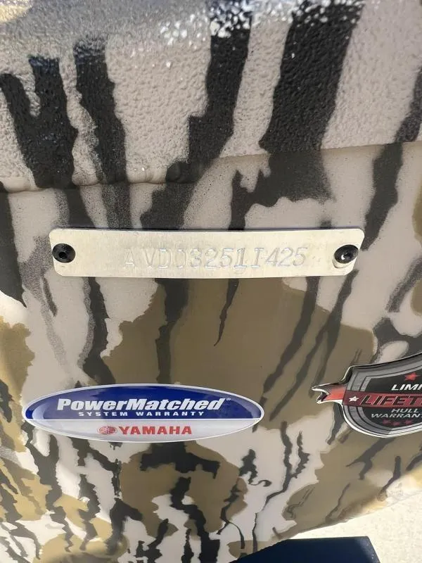 Slide: The Image of Avid 18 Center Console 2025 boat with Yamaha warranty stickers. - 16