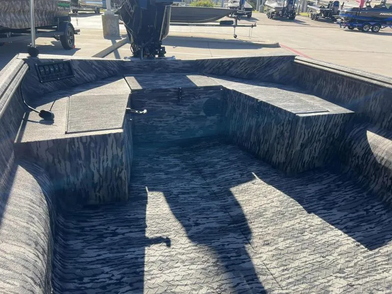 Slide: The Image of 2024 Havoc Boats 1756 MRST interior with camo design, spacious seating, and storage compartments. - 10