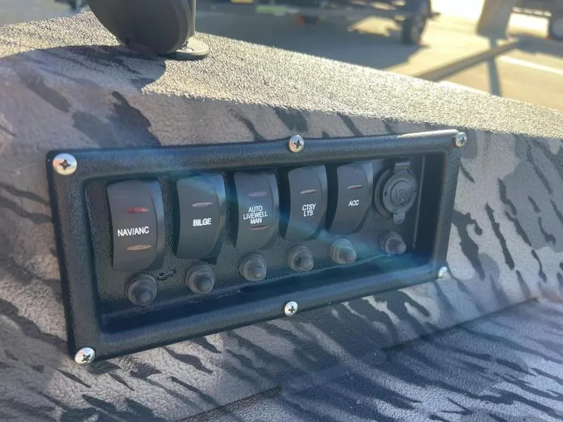 Slide: The Image of Control panel of 2024 Havoc Boats 1756 MRST with various switches. - 11