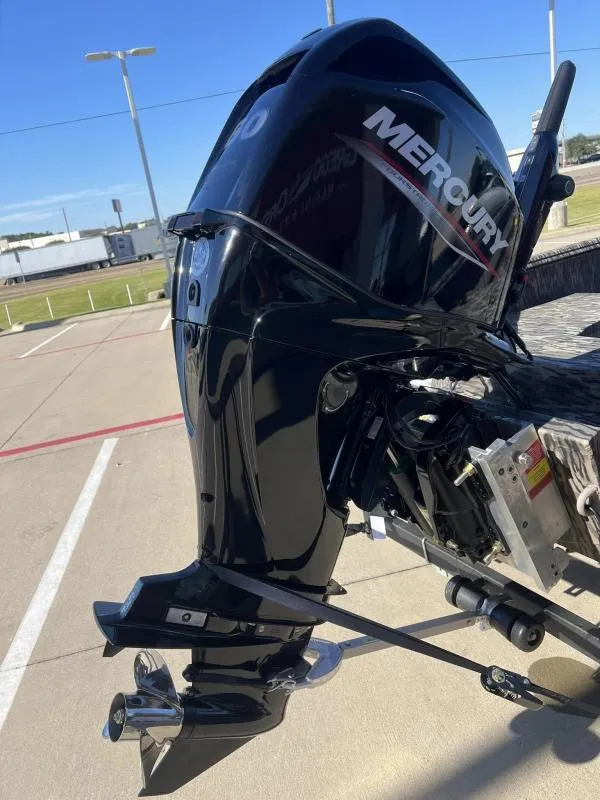 Slide: The Image of 2024 Havoc Boats 1756 MRST with Mercury outboard motor in parking lot. - 13