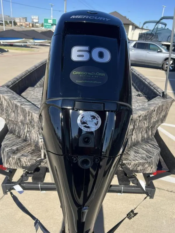 Slide: The Image of 2024 Havoc Boats 1756 MRST with Mercury 60 engine, parked outdoors. - 14