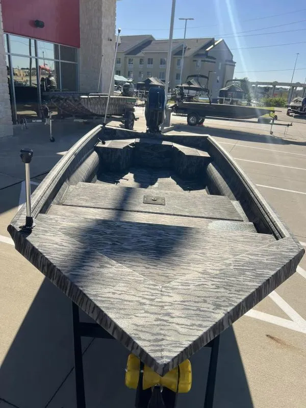 Slide: The Image of 2024 Havoc Boats 1756 MRST in parking lot, showcasing sleek design and modern features. - 7