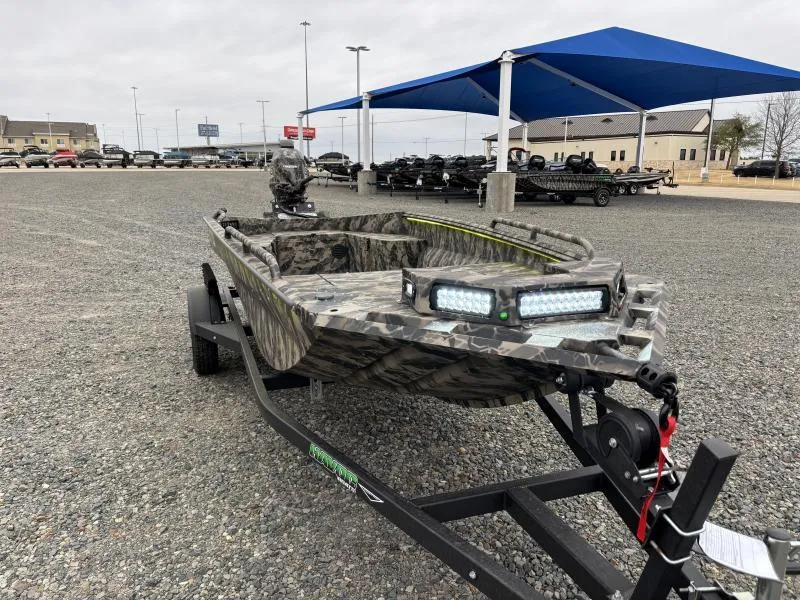Slide: The Image of 2024 Havoc Boats 1653 MSTC camo boat on trailer in outdoor dealership lot. - 1