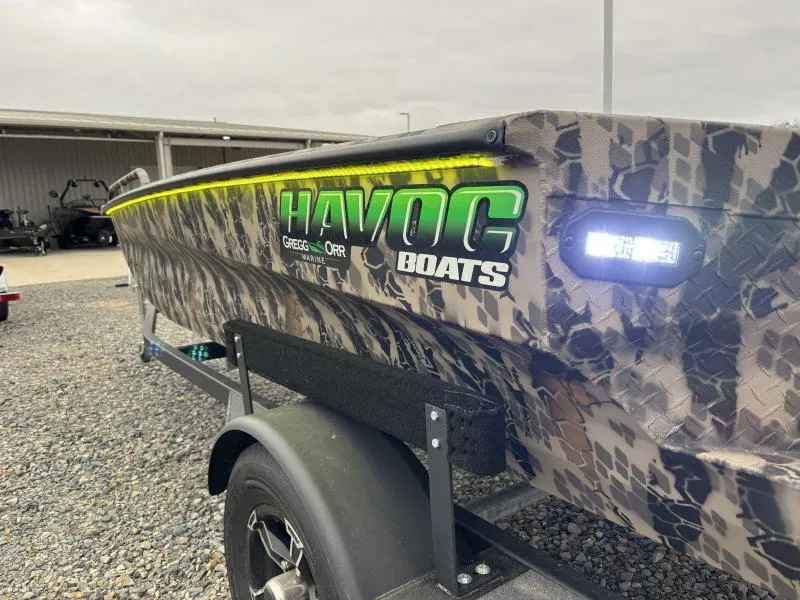 Slide: The Image of 2024 Havoc Boats 1653 MSTC with camouflage design and LED lights on trailer. - 7