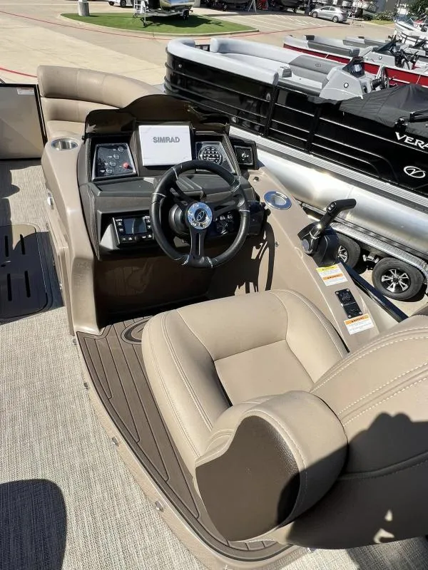 Slide: The Image of 2024 Veranda VTX25RC boat interior with steering console and beige seating. - 14