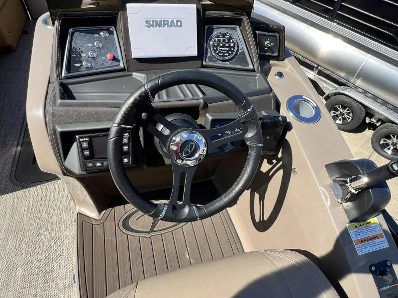 Slide: The Image of 2024 Veranda VTX25RC boat dashboard with steering wheel and Simrad display. - 17