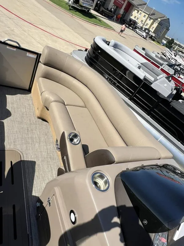 Slide: The Image of 2024 Veranda VTX25RC pontoon boat with beige seating and modern design. - 19