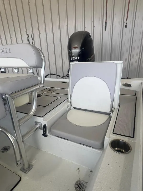Slide: The Image of 2023 Excel Boats 220 Bay Pro interior with seating and Yamaha 150 engine. - 13