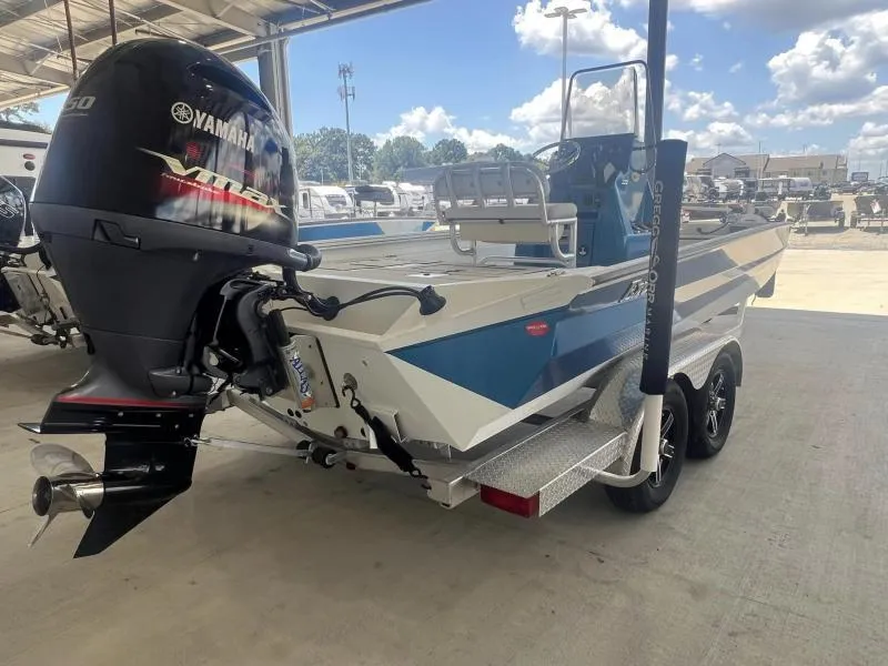 Slide: The Image of 2023 Excel Boats 220 Bay Pro with Yamaha engine, parked under a sunny sky. - 3