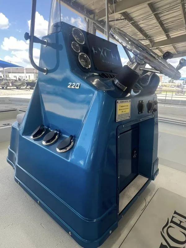 Slide: The Image of 2023 Excel Boats 220 Bay Pro console with steering wheel and gauges. - 7