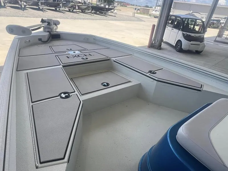 Slide: The Image of 2023 Excel Boats 220 Bay Pro interior with storage compartments and seating. - 8