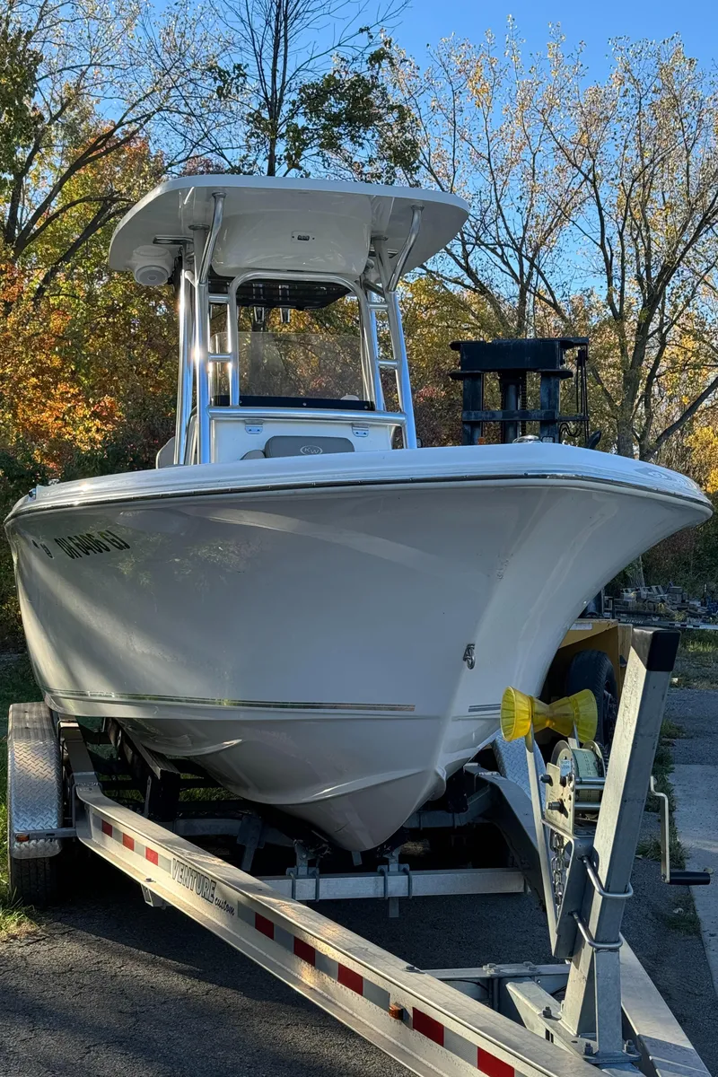 Slide: The Image of 2022 Key West 239 FS boat on trailer, surrounded by autumn trees. - 1