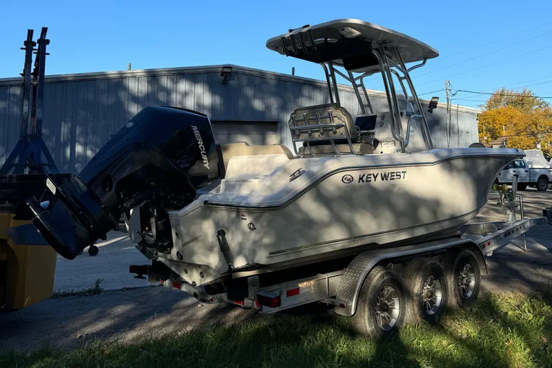 Slide: The Image of 2022 Key West 239 FS boat on trailer, parked outdoors. - 3