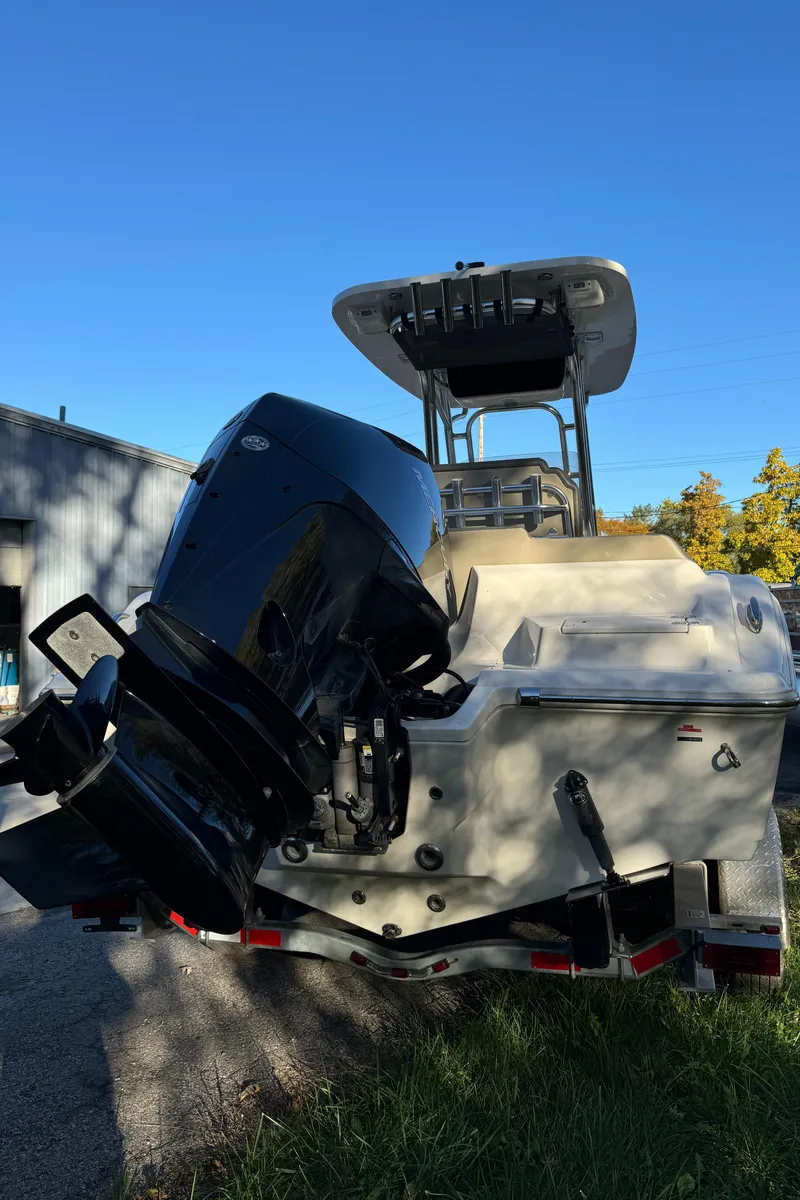 Slide: The Image of 2022 Key West 239 FS boat with outboard motor, parked outdoors. - 4