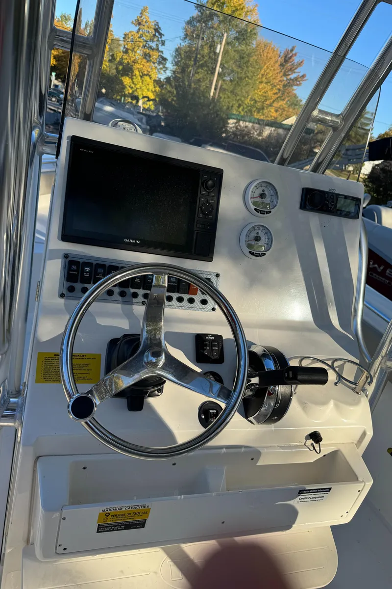 Slide: The Image of 2022 Key West 239 FS boat dashboard with steering wheel and gauges. - 6