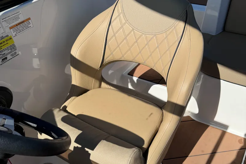 Slide: The Image of 2023 Bayliner DX2000 boat seat with beige upholstery and diamond stitching. - 10