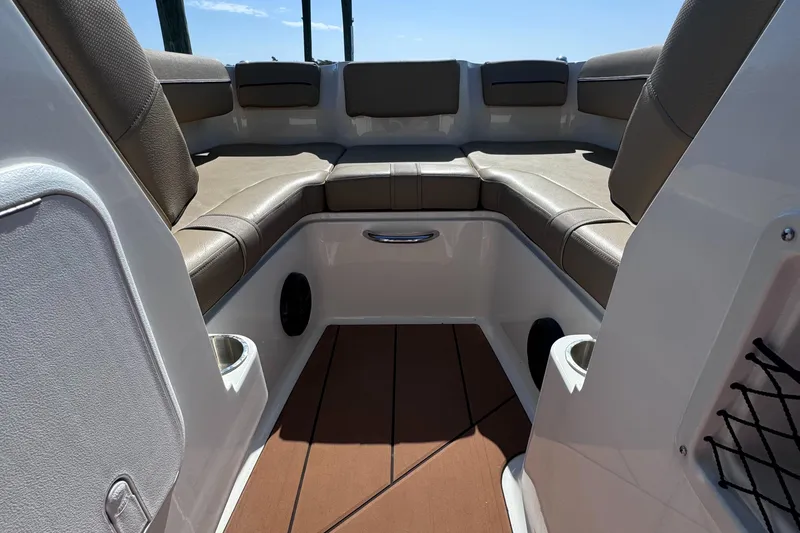 Slide: The Image of 2023 Bayliner DX2000 boat interior with cushioned seating and storage compartments. - 12