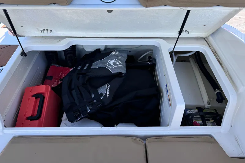 Slide: The Image of Storage compartment of 2023 Bayliner DX2000 boat with gear and equipment. - 16