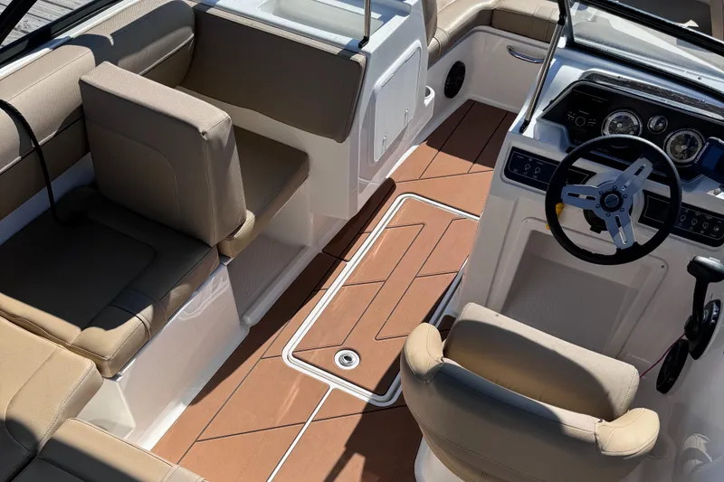 Slide: The Image of 2023 Bayliner DX2000 boat interior with tan seating and modern dashboard. - 7