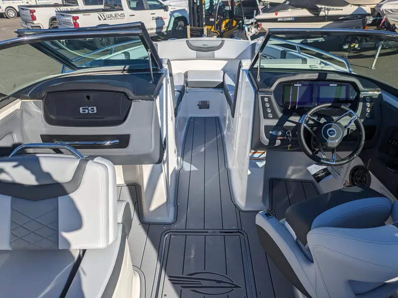 Slide: The Image of 2025 Chaparral 247 SSX boat interior with modern dashboard and seating. - 13
