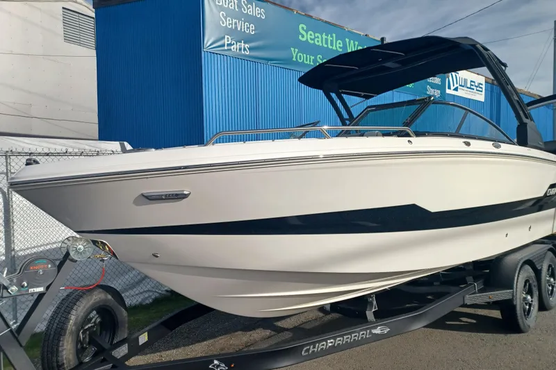 Slide: The Image of 2025 Chaparral 247 SSX boat on trailer, displayed at a dealership. - 2