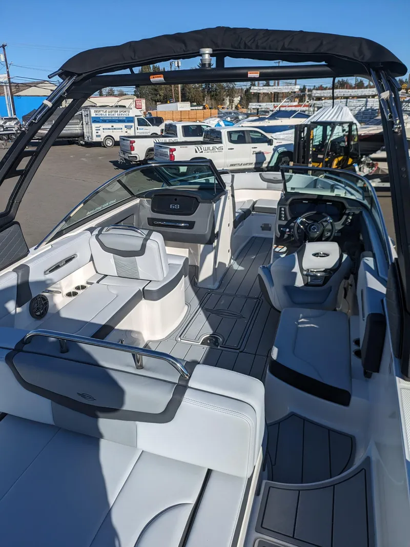 Slide: The Image of 2025 Chaparral 247 SSX boat interior with sleek seating and modern dashboard. - 20