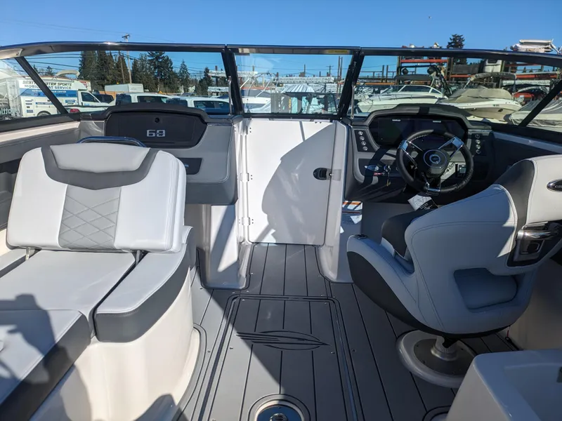 Slide: The Image of 2025 Chaparral 247 SSX boat interior with modern seating and steering wheel. - 22