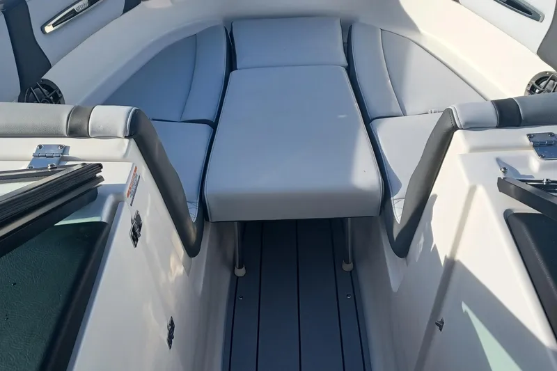 Slide: The Image of 2025 Chaparral 247 SSX boat interior with cushioned seating and sleek design. - 29