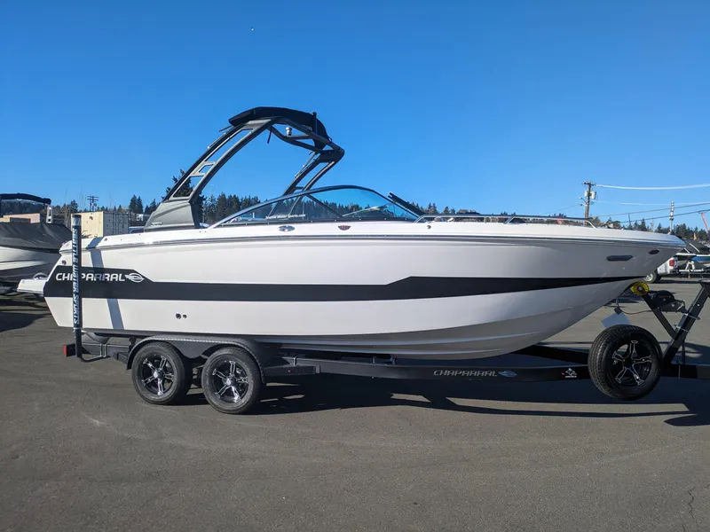 Slide: The Image of 2025 Chaparral 247 SSX boat on trailer, sleek design, parked outdoors. - 3
