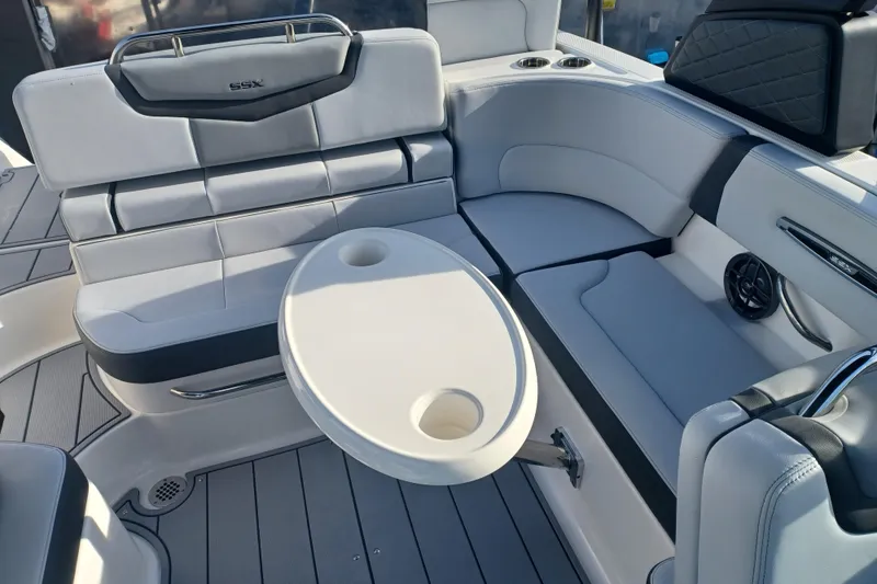 Slide: The Image of 2025 Chaparral 247 SSX boat interior with white seating and round table. - 31
