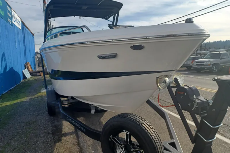 Slide: The Image of 2025 Chaparral 247 SSX boat on trailer, side view, outdoors. - 33