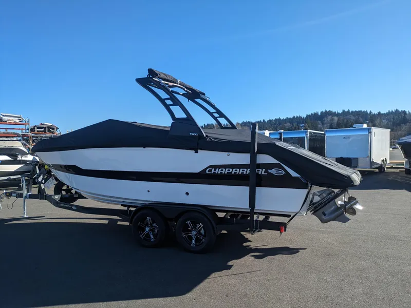 Slide: The Image of 2025 Chaparral 247 SSX boat on trailer, sleek design, parked outdoors. - 5