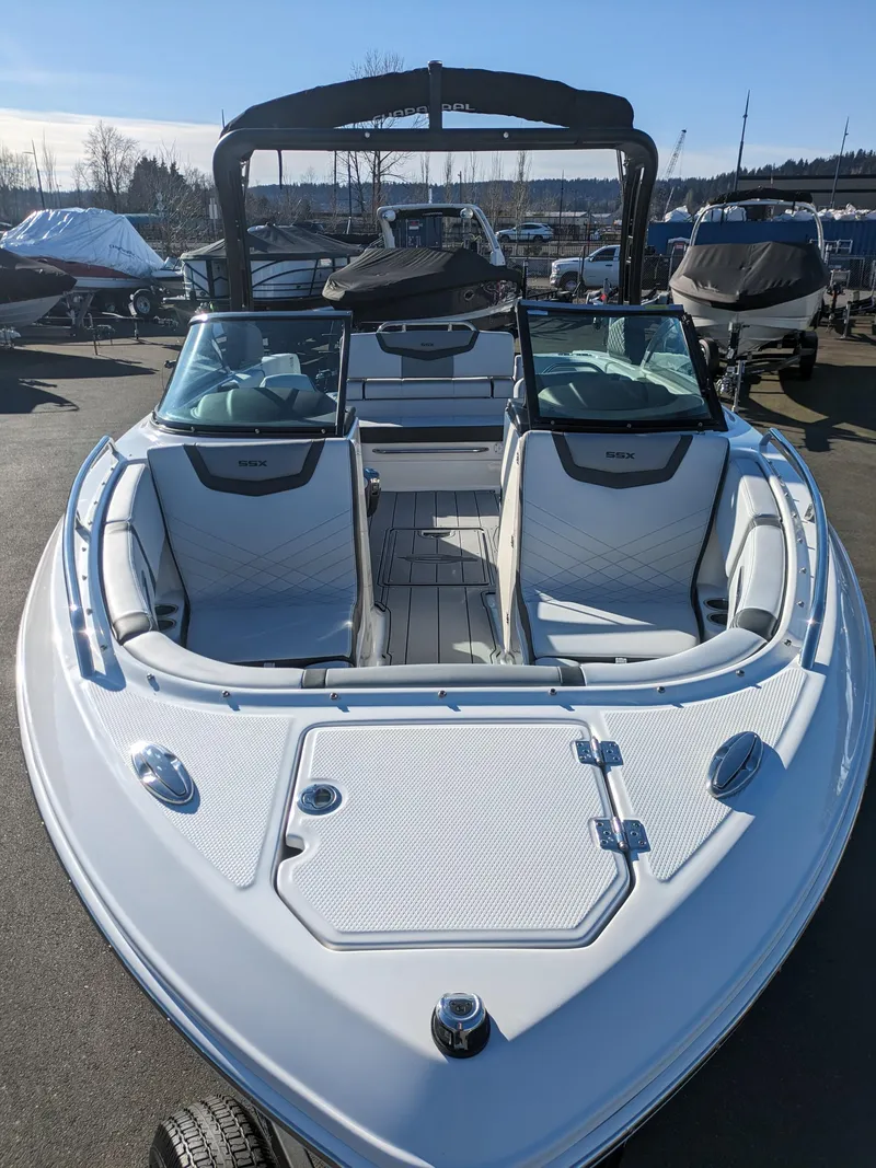 Slide: The Image of 2025 Chaparral 247 SSX boat, white exterior, spacious seating, docked outdoors. - 8
