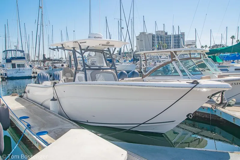 The Image of 2022 Sea Fox 288 Commander boat docked in a marina, surrounded by other vessels. - 0